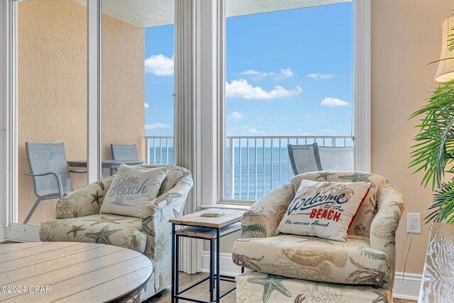 living room featuring hardwood / wood-style floors and a water view