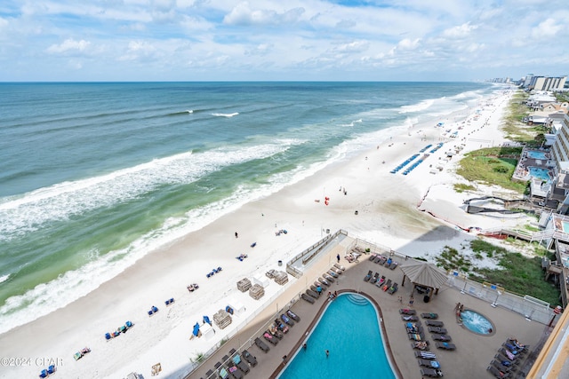 birds eye view of property featuring a beach view and a water view