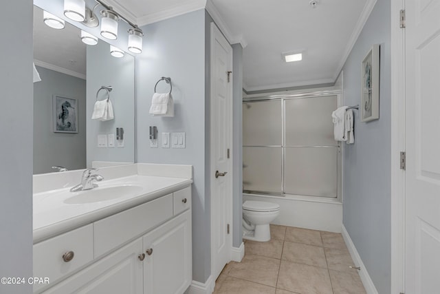 bathroom featuring vanity, enclosed tub / shower combo, crown molding, toilet, and tile patterned floors