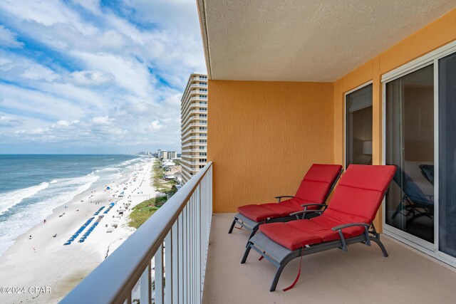 balcony with a view of the beach and a water view