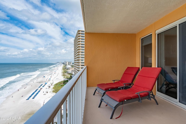 balcony with a view of the beach and a water view