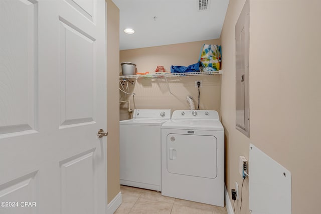 laundry room with light tile patterned floors, visible vents, washing machine and dryer, and laundry area