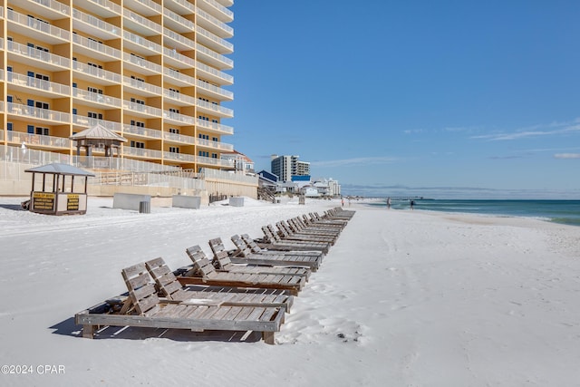 view of property's community featuring a beach view and a water view