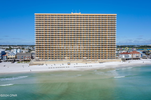 view of property featuring a beach view and a water view