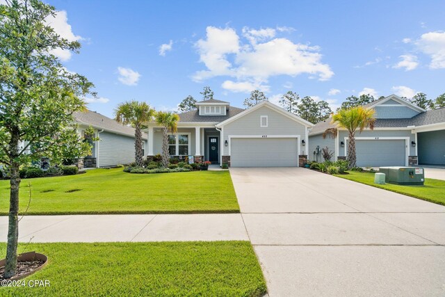 craftsman-style home with a garage and a front yard