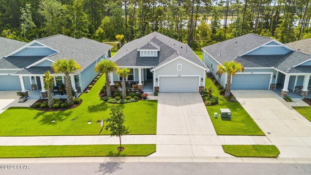 craftsman inspired home featuring a garage and a front yard