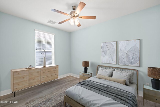 bedroom with hardwood / wood-style flooring and ceiling fan