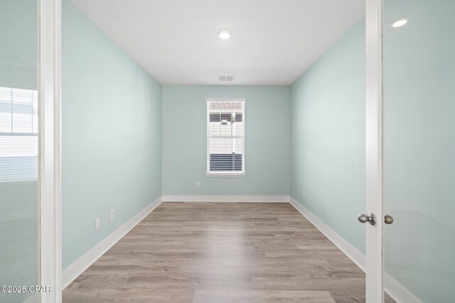 spare room with light wood-type flooring and french doors