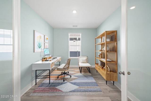 home office with french doors and hardwood / wood-style flooring