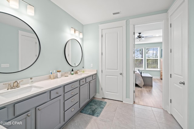 bathroom featuring tile patterned flooring, vanity, and ceiling fan