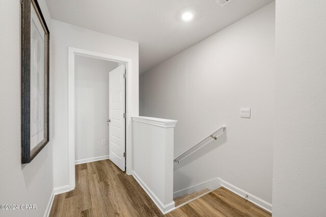 hallway with wood-type flooring