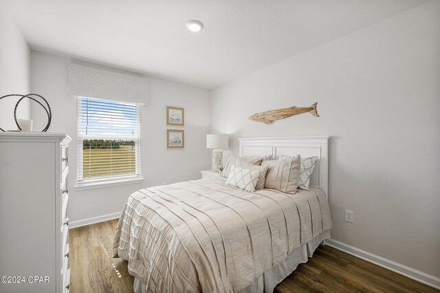 bedroom with dark hardwood / wood-style flooring