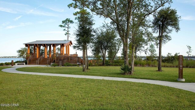 view of community featuring a lawn and a water view