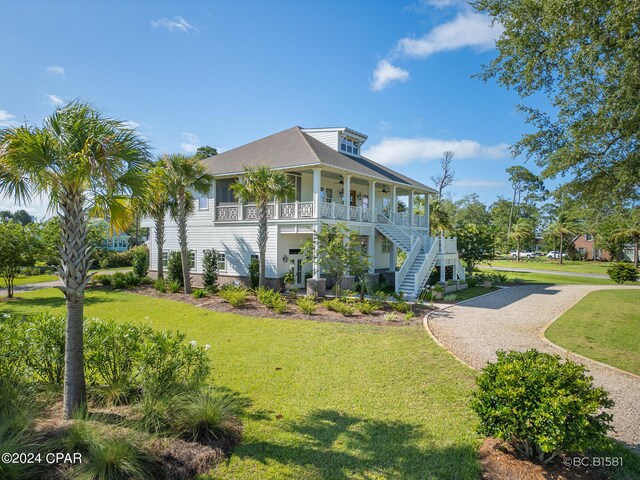 view of front of home with a front yard and a porch