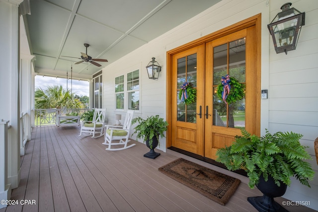 wooden terrace featuring french doors, ceiling fan, and covered porch