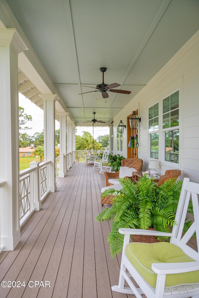 wooden terrace featuring ceiling fan and a porch