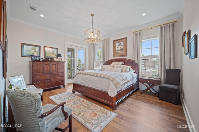 bedroom featuring multiple windows, wood-type flooring, access to exterior, and french doors