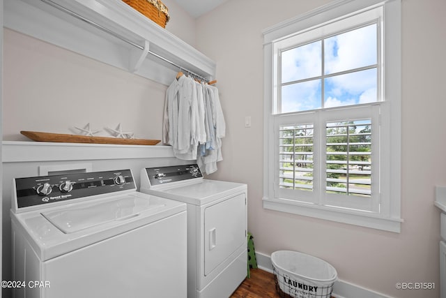 laundry area with washing machine and clothes dryer and dark hardwood / wood-style flooring