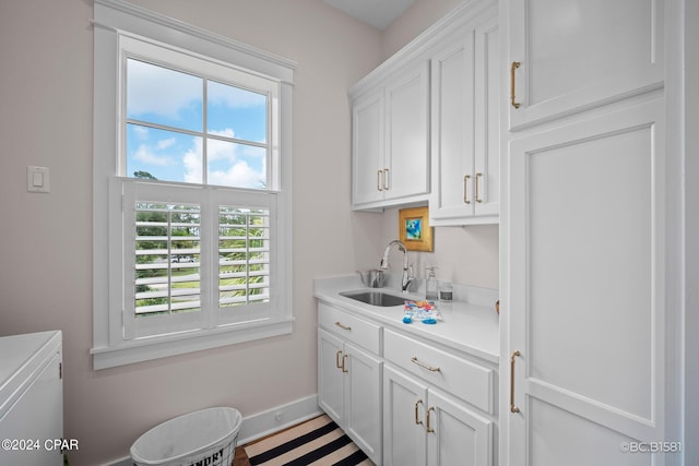 kitchen with white cabinetry and sink