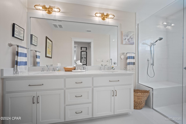 bathroom featuring tiled shower and vanity