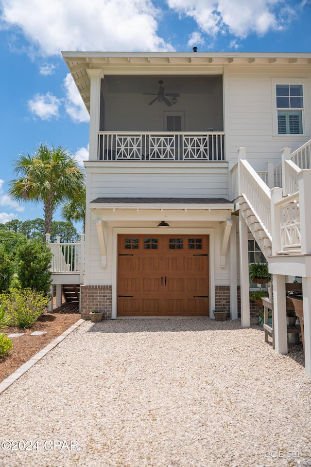 view of front of home with a garage and ceiling fan