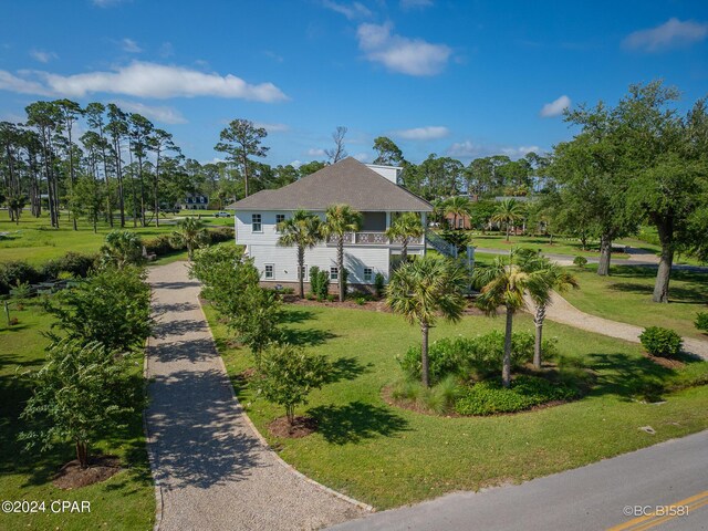 view of home's community featuring a lawn