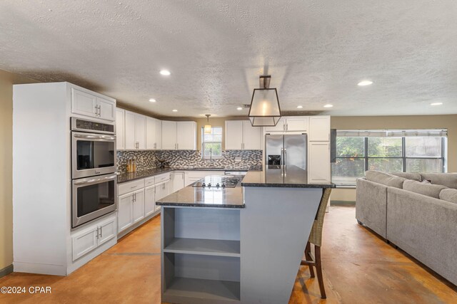 kitchen featuring a kitchen island, stainless steel appliances, and white cabinetry