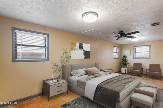 bedroom with a textured ceiling and ceiling fan