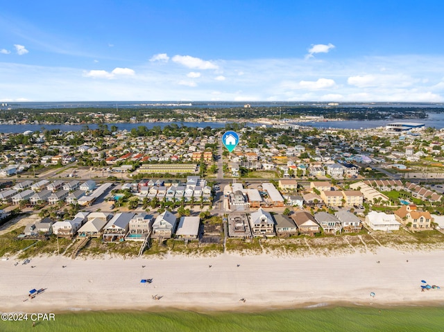 birds eye view of property with a water view and a view of the beach