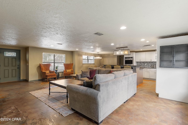 living room with a textured ceiling