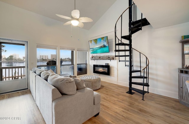 living room with plenty of natural light, a water view, and wood-type flooring