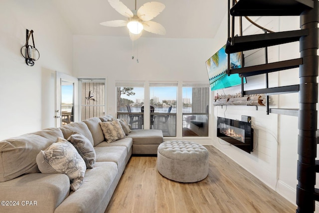 living room with light hardwood / wood-style flooring and ceiling fan