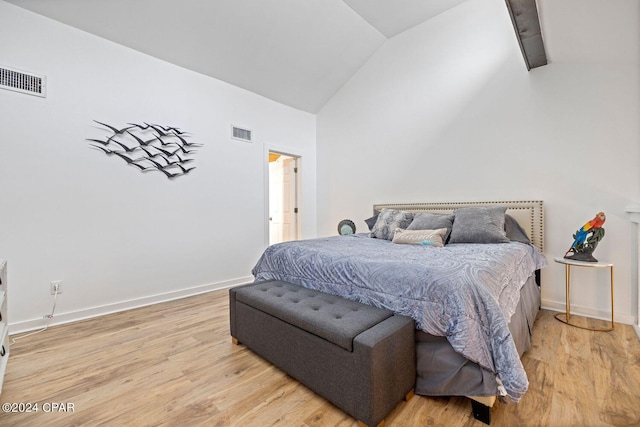 bedroom featuring vaulted ceiling and light hardwood / wood-style flooring