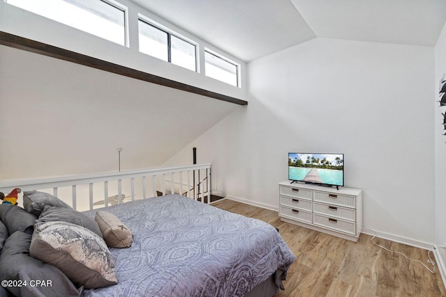 bedroom featuring light hardwood / wood-style floors and vaulted ceiling