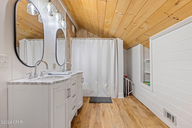 bathroom featuring wooden ceiling, lofted ceiling, wooden walls, vanity, and hardwood / wood-style flooring