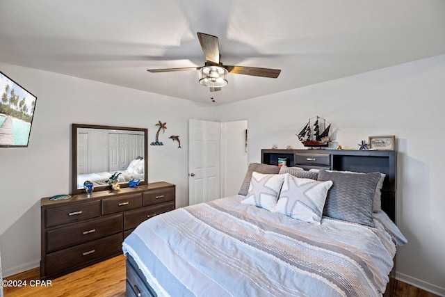 bedroom featuring a closet, light hardwood / wood-style flooring, and ceiling fan