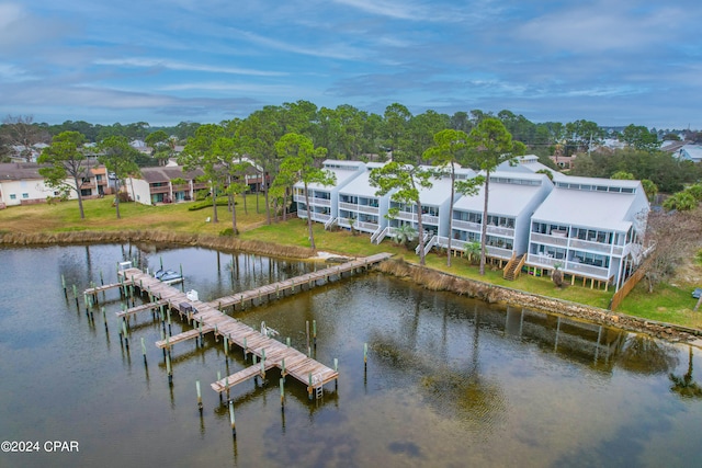 dock area featuring a lawn and a water view