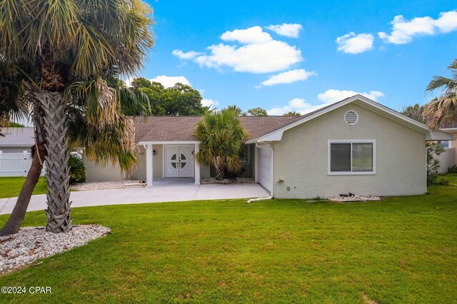 view of front facade featuring a garage and a front lawn