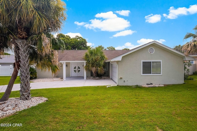 ranch-style house with driveway, a shingled roof, a front lawn, and stucco siding