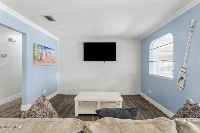 living room with dark hardwood / wood-style flooring and ornamental molding