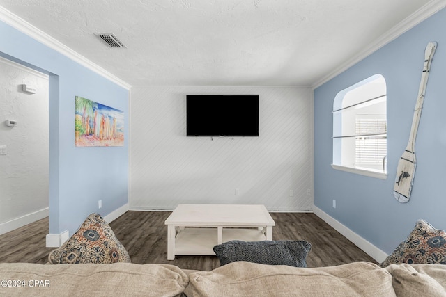 living room featuring ornamental molding, wood finished floors, and visible vents