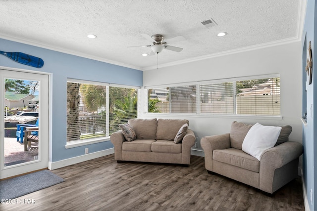 living room with dark hardwood / wood-style floors, a wealth of natural light, and ceiling fan