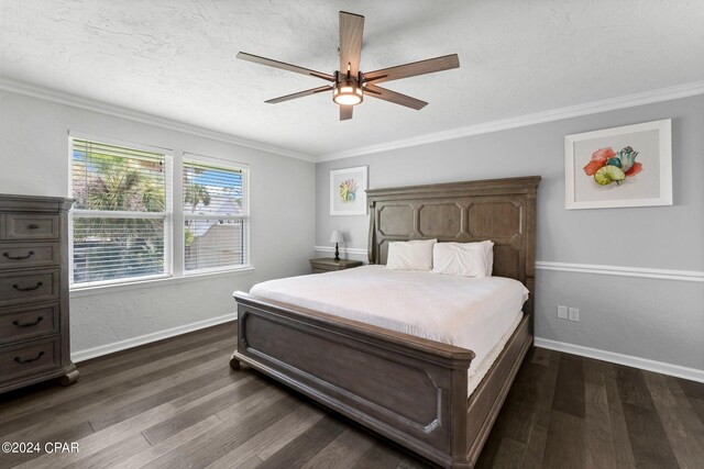 bedroom with dark hardwood / wood-style floors, a textured ceiling, ornamental molding, and ceiling fan