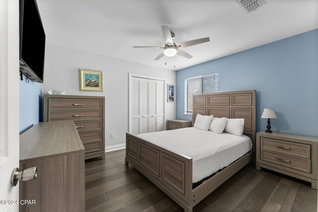 bedroom featuring dark hardwood / wood-style flooring, a closet, and ceiling fan