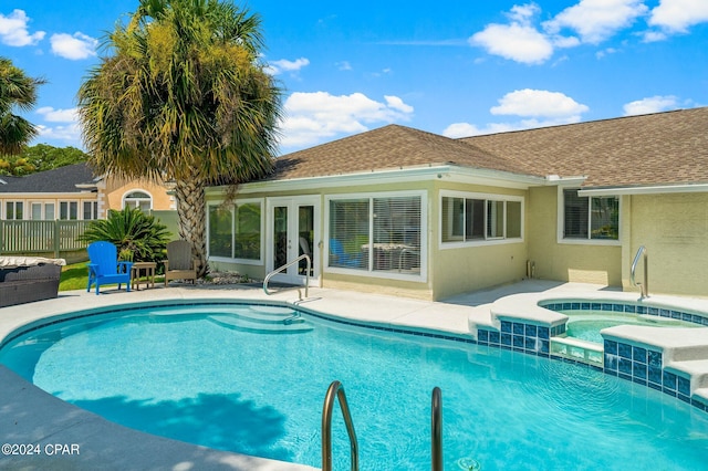 view of swimming pool featuring a patio area and an in ground hot tub