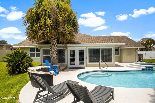 view of swimming pool featuring a patio and french doors