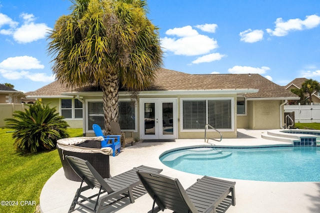 view of swimming pool with a fenced in pool, french doors, a patio, fence, and an in ground hot tub