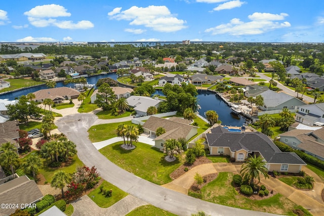 drone / aerial view featuring a water view and a residential view