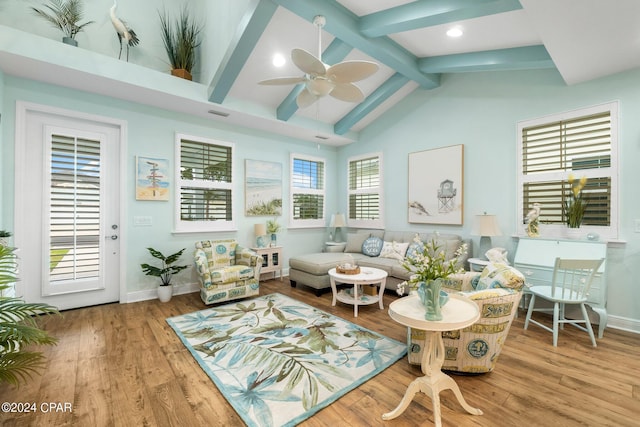 living room with high vaulted ceiling, light wood-type flooring, beam ceiling, and ceiling fan