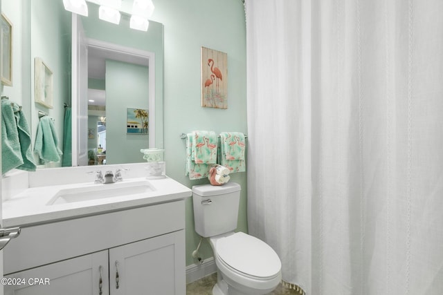 bathroom featuring toilet and vanity